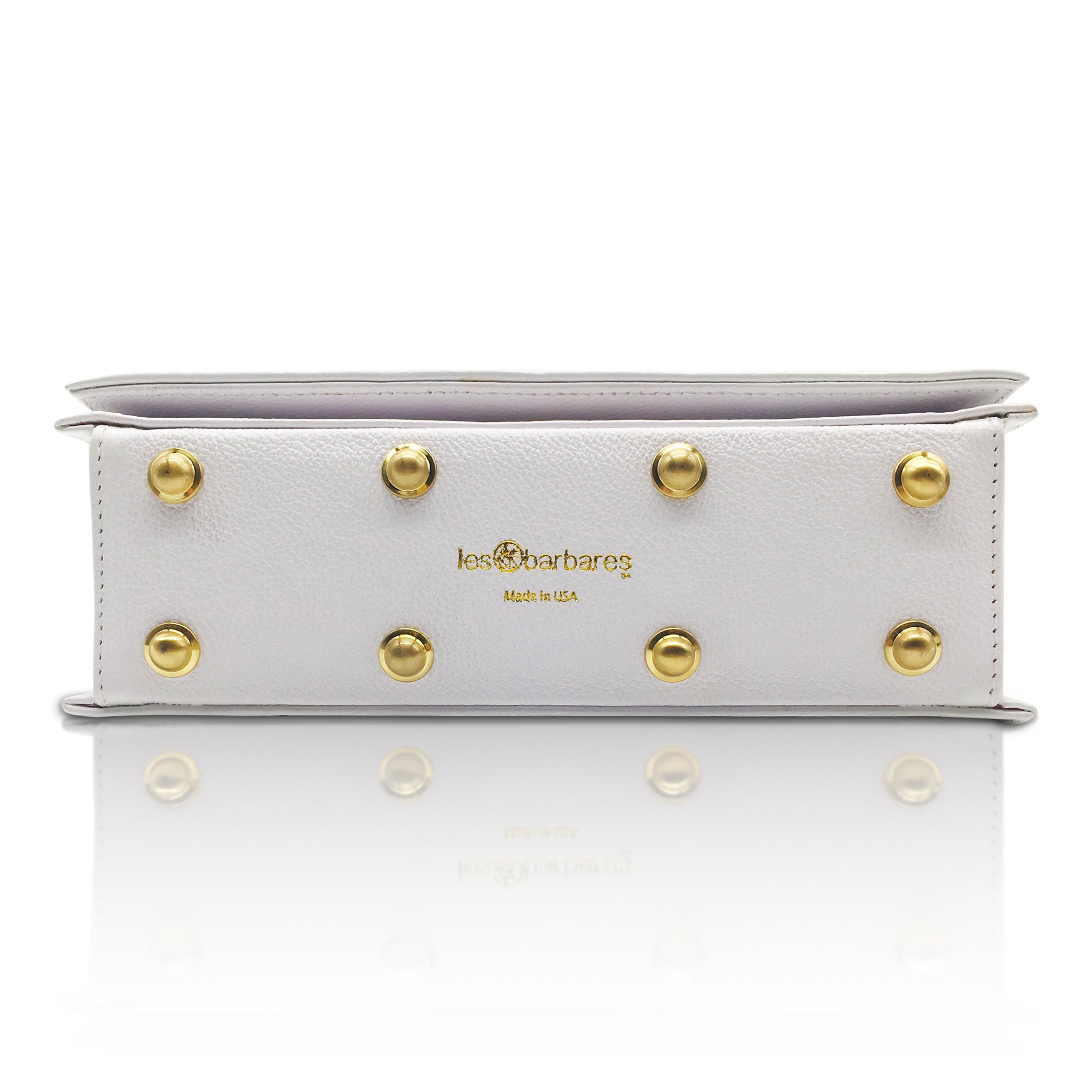 Showing the base of the genuine soft white leather handbag. with the 8 brass rivets to protect the base