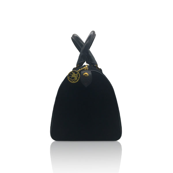 side view of the genuine black suede handbag showing the quality of the stitching and the medallion on the zipper