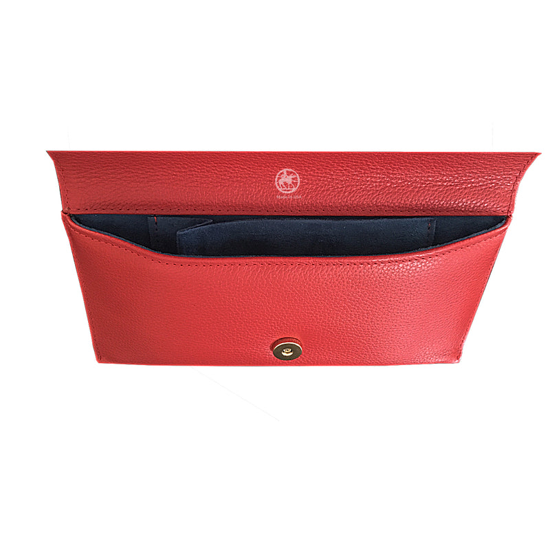 Showing the inside of the clutch bag. Raspberry pink leather interior with brass fastener