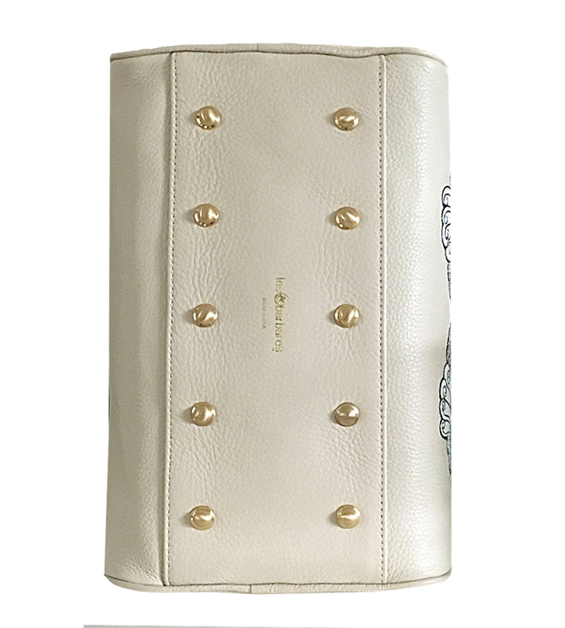 Showing the underside of the Beige soft Italian leather mini handbag, with 10 brass rivets to protect the base.