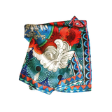 Folded Blue 100% silk scarf with red and pinks and a black and white eagle in the center.